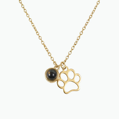 Gold necklace with paw print and black gemstone pendant on a white background, projection necklace, premium gold memorial pet necklace 